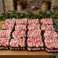 Raw pigs in blankets on trays in a festive farmhouse setting
