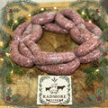 Radmore thick sausages on a wooden board with Christmas surroundings and Radmore branding